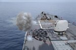 The Arleigh Burke-class guided-missile destroyer USS Ross (DDG 71) fires its Mark 45 5-inch gun while underway in the Mediterranean Sea, July 22, 2021.