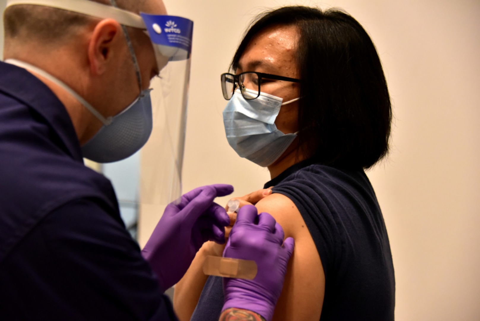 Chief Petty Officer Mary Zepeda is administered the first coronavirus (COVID-19) vaccination at Base Alameda medical clinic in Alameda, Calif., Dec. 16, 2020. Coast Guard efforts to vaccinate its workforce, in collaboration with DoD, will be complementary to a parallel effort by states, territories, and localities, as vaccine supply allows. U.S. Coast Guard photos by Chief Petty Officer Matt Masaschi.