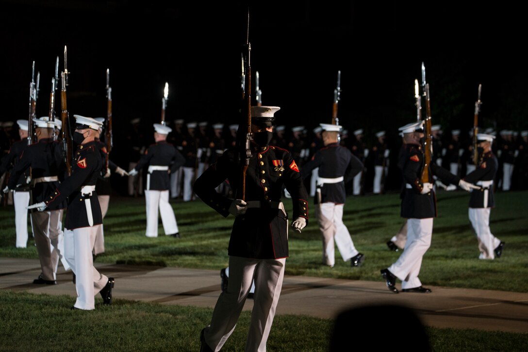 Marines with the Silent Drill Platoon perform during the Friday Evening Parade at Marine Barracks Washington, July 23, 2021.