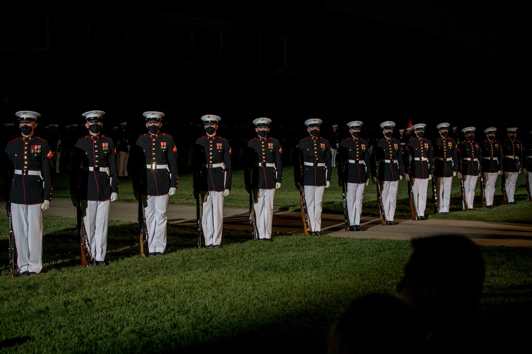 Marines with the Silent Drill Platoon execute their “long line” sequence during the Friday Evening Parade at Marine Barracks Washington, July 23, 2021. The hosting official was Lt. Gen. Mark R. Wise, Deputy Commander for Aviation, and the guest of honor was Ambassador Koji Tomita, Ambassador Extraordinary and Plenipotentiary of Japan to the United States. (U.S. Marine Corps photo by Lance Cpl. Mark Morales)
