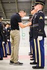 Kevin Palladino, one of just two national trainers for the Army National Guard Military Funeral Honors Program, meticulously inspects a Soldier’s Army Service Uniform during the intense two-week Level 2 Funeral Honors Course held July 11-24 at Fort Indiantown Gap, Pa.