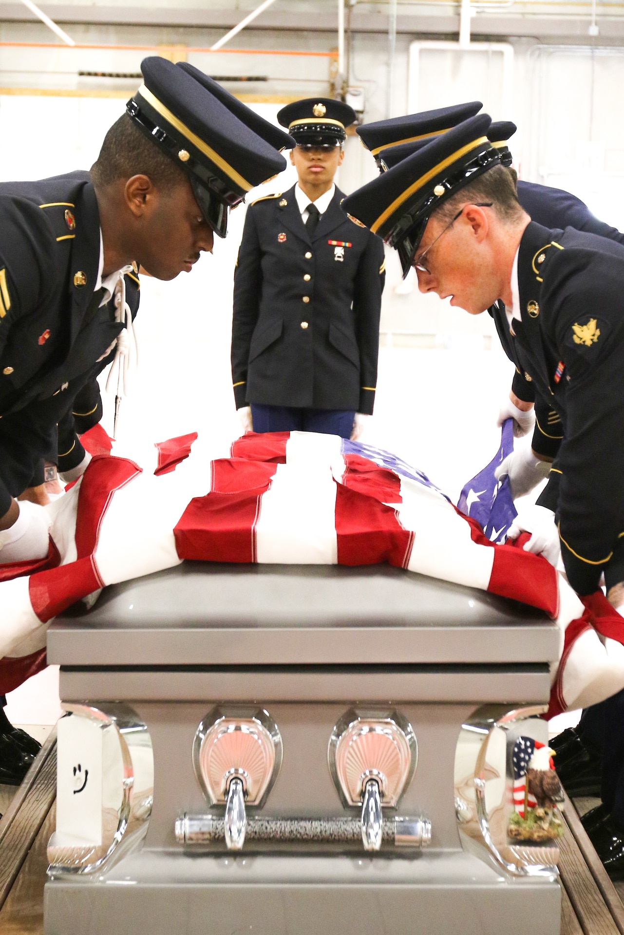 Seven of the thirteen Soldiers participating in the Army National Guard Military Funeral Honors Level 2 course practice pallbearing and folding the flag as they prepare for their final test. Soldiers from seven different states participated in the 80-hour course held 11-24 July at Fort Indiantown Gap, Pa.