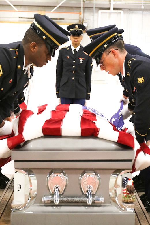 Seven of the thirteen Soldiers participating in the Army National Guard Military Funeral Honors Level 2 course practice pallbearing and folding the flag as they prepare for their final test. Soldiers from seven different states participated in the 80-hour course held 11-24 July at Fort Indiantown Gap, Pa.
