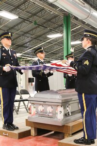 Soldiers participating in the Army National Guard Military Funeral Honors Level 2 course practice folding the flag as they prepare for their final test. Soldiers from seven different states participated in the 80-hour course held 11-24 July at Fort Indiantown Gap, Pa.