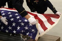 Trainers from the National Guard Bureau National Military Funeral Honors Program observe students demonstrating their proficiency of the six-Soldier flag fold during the MFH train-the-trainer course at Fort Indiantown Gap. Thirteen Soldiers from across the nation traveled to Pennsylvania to earn the NGB’s certification July 22 to become a MFH trainer. After successful completion of the course, the Soldiers will return to their states to train Soldiers in their home units to carry out MFH duties.