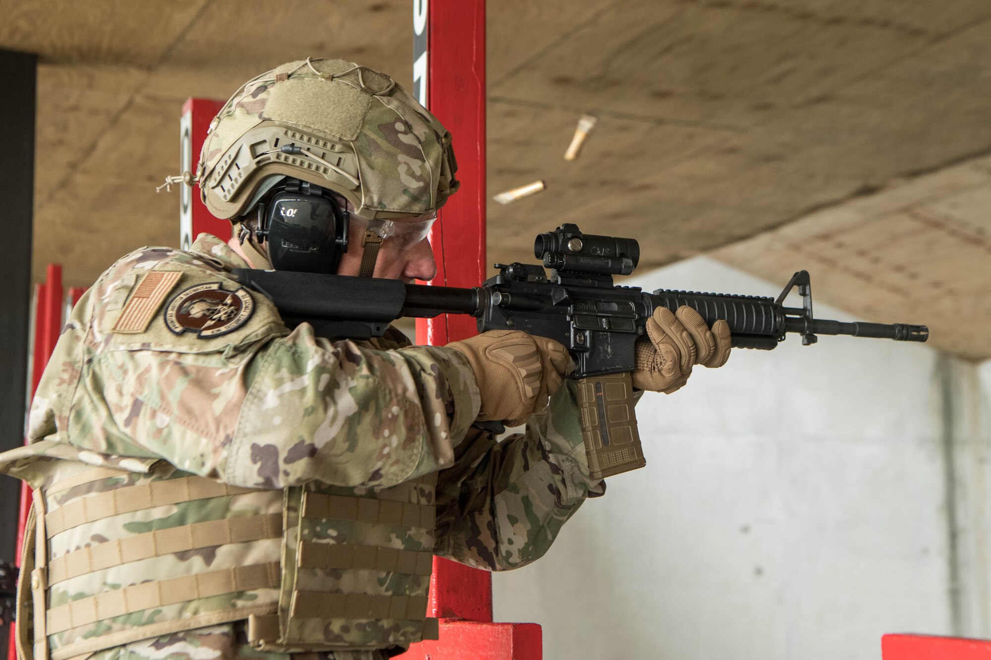 Col. Matthew Husemann, 436th Airlift Wing commander, fires a three-round burst from an M4 carbine at the Combat Arms Training and Maintenance facility on Dover Air Force Base, Delaware, July 26, 2021. Husemann toured the facility and fired the M18 pistol and M4 carbine. (U.S. Air Force photo by Mauricio Campino)