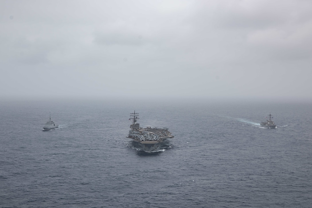 ARABIAN SEA  (July 24, 2021) – French Navy frigate FS Languedoc (D653), left, aircraft carrier USS Ronald Reagan (CVN 76), center, and guided-missile destroyer USS Halsey (DDG 97) steam in formation in the Arabian Sea, July 24. Ronald Reagan is deployed to the U.S. 5th Fleet area of operations in support of naval operations to ensure maritime stability and security in the Central Region, connecting the Mediterranean and Pacific through the western Indian Ocean and three strategic choke points. (U.S. Navy photo by Mass Communication Specialist 2nd Class Jason Tarleton)