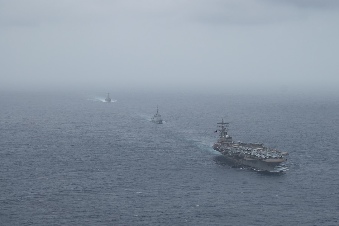 ARABIAN SEA  (July 24, 2021) – Aircraft carrier USS Ronald Reagan (CVN 76), front, French Navy frigate FS Languedoc (D653), middle, and guided-missile destroyer USS Halsey (DDG 97) steam in formation in the Arabian Sea, July 24. Ronald Reagan is deployed to the U.S. 5th Fleet area of operations in support of naval operations to ensure maritime stability and security in the Central Region, connecting the Mediterranean and Pacific through the western Indian Ocean and three strategic choke points. (U.S. Navy photo by Mass Communication Specialist 2nd Class Jason Tarleton)