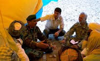 While serving as an interpreter for the U.S. military, Fahim Masoud (center), went on several missions with senior U.S. Army officers for meetings with local Afghanistan officials.