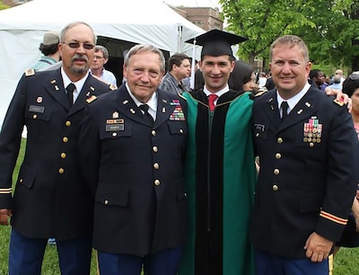 Fahim Masoud, second from right, graduated from Washington University in St. Louis, Missouri. Among those in attendance was retired Iowa Army National Guard CW3 James Ditter, right. Ditter sponsored Masoud to the United States on a student visa.