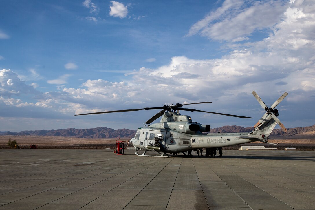 U.S. Marines with Marine Light Helicopter Attack Squadron 773, Marine Aircraft Group 49, 4th Marine Aircraft Wing, prepare a Bell UH-1Y Venom helicopter for takeoff before beginning Fire Support Coordination Exercise at Marine Corps Air Ground Combat Center, Twentynine Palms, California, July 21, 2021. FSCEX is designed to challenge the Marine Air Ground Task Force, other U.S. Forces, and partner nation military’s ability to coordinate a wide range of high caliber and explosive ordnance from multiple ground and air platforms, ensuring success on a modern battlefield. (U.S. Marine Corps photo by Lance Cpl. Joshua Sechser)