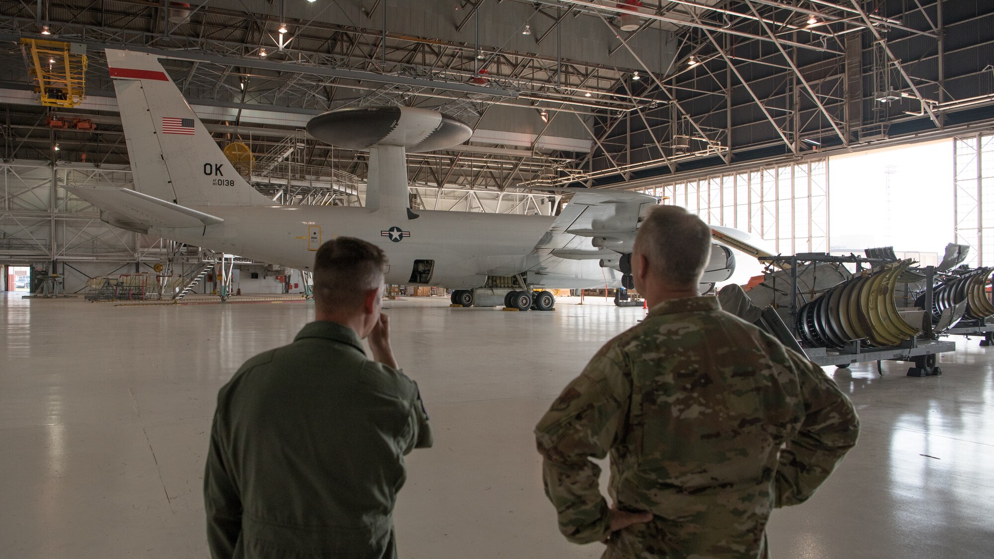 Two men looking at an airplane