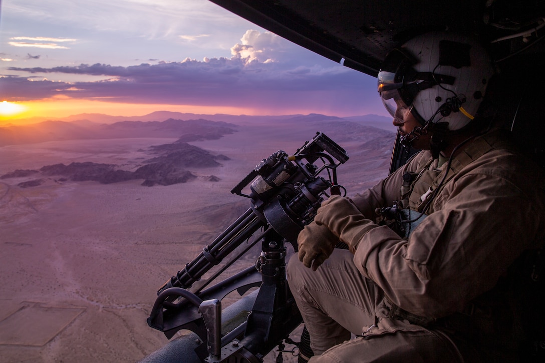 U.S. Marine Corps Sgt. Reginald Smith, helicopter aircrew Marine, Marine Light Helicopter Attack Squadron 773, Marine Aircraft Group 49, 4th Marine Aircraft Wing, checks his watch while riding in a Bell UH-1Y Venom helicopter during Fire Support Coordination Exercise at Marine Corps Air Ground Combat Center, Twentynine Palms, California, July 21, 2021. FSCEX is designed to challenge the Marine Air Ground Task Force, other U.S. Forces and partner nations military’s ability to coordinate a wide range of high caliber and explosive ordnance from multiple ground and air platforms, ensuring success on a modern battlefield. (U.S. Marine Corps photo by Lance Cpl. Joshua Sechser)