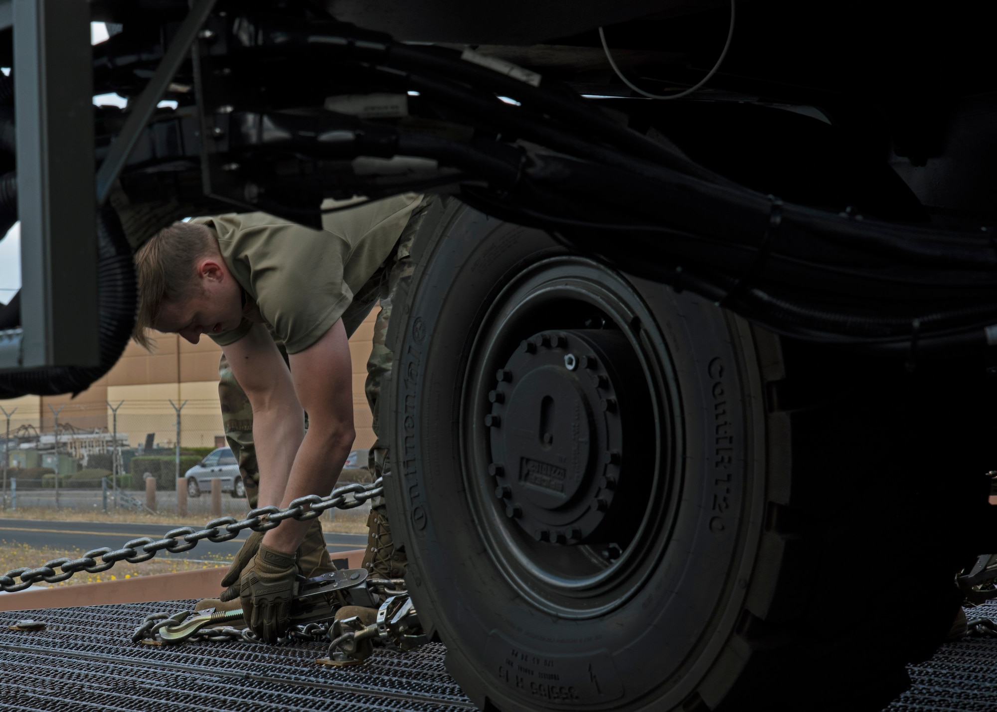 U.S. Air Force Senior Airman Trenton Dancer, air freight operations specialist with the 62nd Aerial Port Squadron, secures a vehicle during an aircraft upload training at Joint Base Lewis-McChord, Washington, July 21, 2021. Dancer and his team will compete in the 2021 Pacific Air Forces (PACAF) Aerial Port Dawg Rodeo to showcase their job knowledge, capabilities and develop esprit de corps with other Port Dawgs. (U.S. Air Force photo by Senior Airman Zoe Thacker)