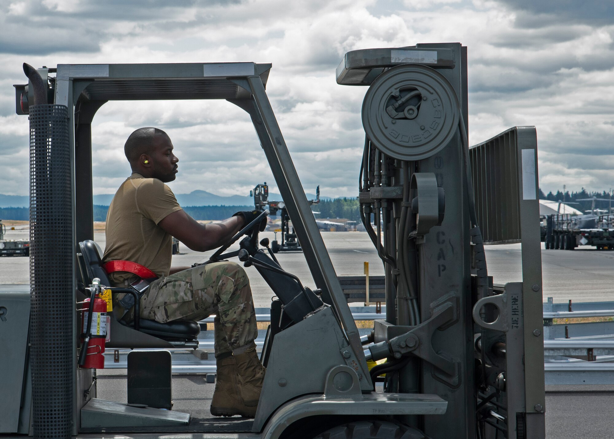 U.S. Air Force Staff Sgt. Wesley Valentine, passenger service supervisor with the 62nd Aerial Port Squadron, operates a forklift during a 10K forklift skills course training at Joint Base Lewis-McChord, Washington, July 21, 2021. Valentine, along with the other six Airmen on his team, will compete in the 2021 Pacific Air Forces (PACAF) Port Dawg Rodeo at Joint Base Pearl Harbor-Hickam, Hawaii, in August. (U.S. Air Force photo by Senior Airman Zoe Thacker)
