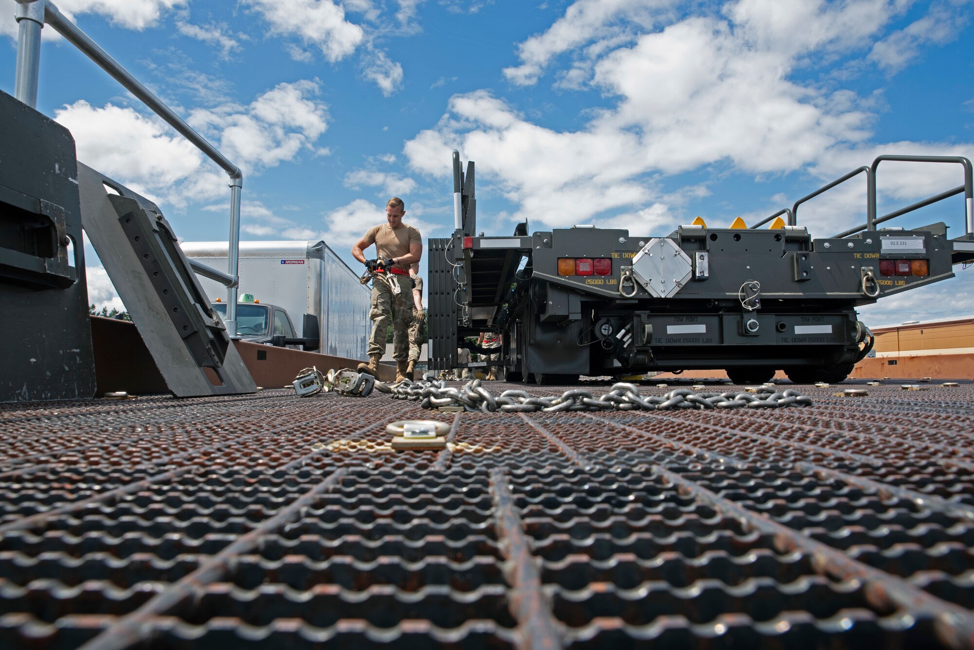 U.S. Air Force Senior Airman Connor Dickson, ATOC information controller with the 62nd Aerial Port Squadron, prepares to secure a vehicle in a simulated aircraft upload during training at Joint Base Lewis-McChord, Washington, July 21, 2021. Dickson is one of the seven Airmen who will represent the 62nd APS at the 2021 Pacific Air Forces (PACAF) Port Dawg Rodeo at Joint Base Pearl Harbor-Hickam, Hawaii, in August. (U.S. Air Force photo by Senior Airman Zoe Thacker)