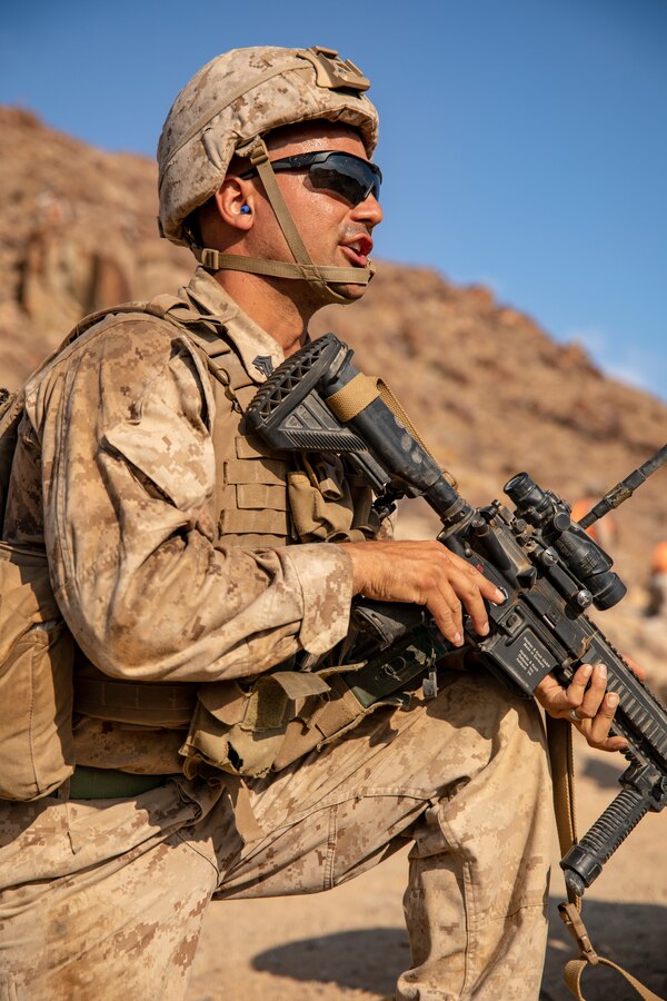 A Marine with Lima Company, 3rd Battalion, 25th Marines, 4th Marine Division, relays commands on Range 400 during Integrated Training Exercise (ITX) 4-21 at Marine Corps Air Ground Combat Center, Twentynine Palms, California on July 22. Range 400 is a company-sized live-fire assault range that requires complex coordination of fires, producing combat-ready Reserve Marines prepared to augment and reinforce the Active Component. (U.S. Marine Corps photo by Sgt. JVonnta Taylor)