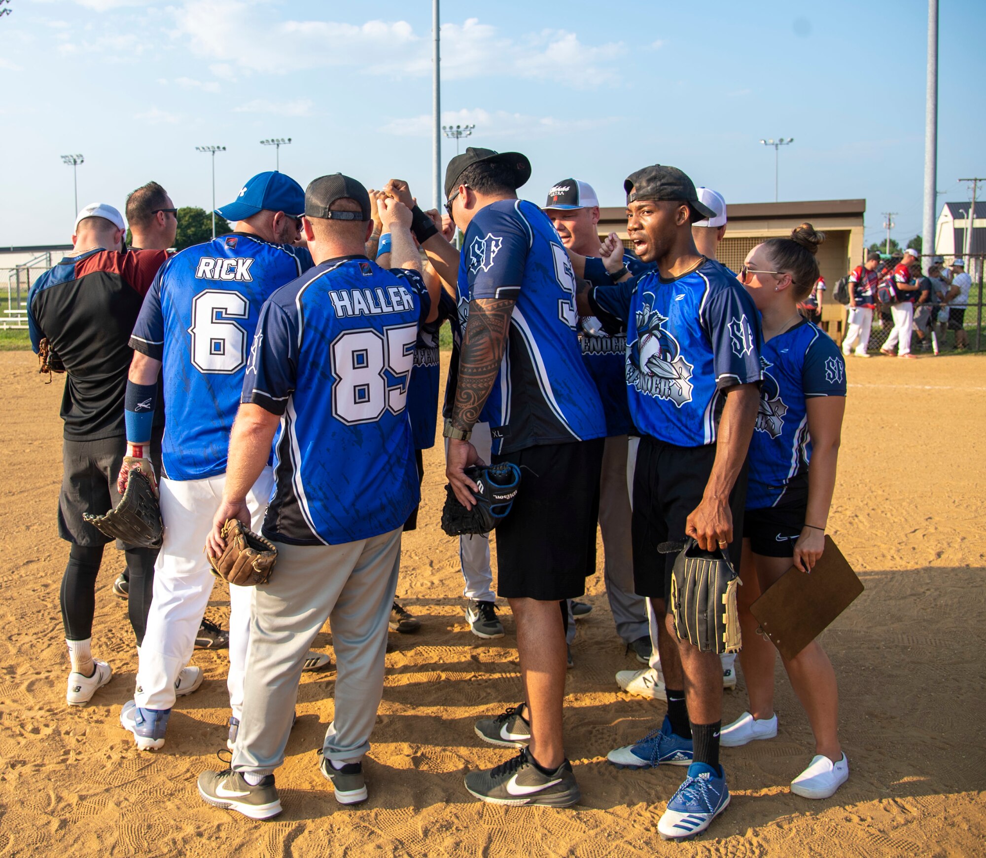Airmen from the 436th Security Forces Squadron cheer after winning their intramural softball game on Dover Air Force Base, Delaware, July 26, 2021. The 436th SFS won the game 13-4. (U.S. Air Force photo by Tech. Sgt. Nicole Leidholm)