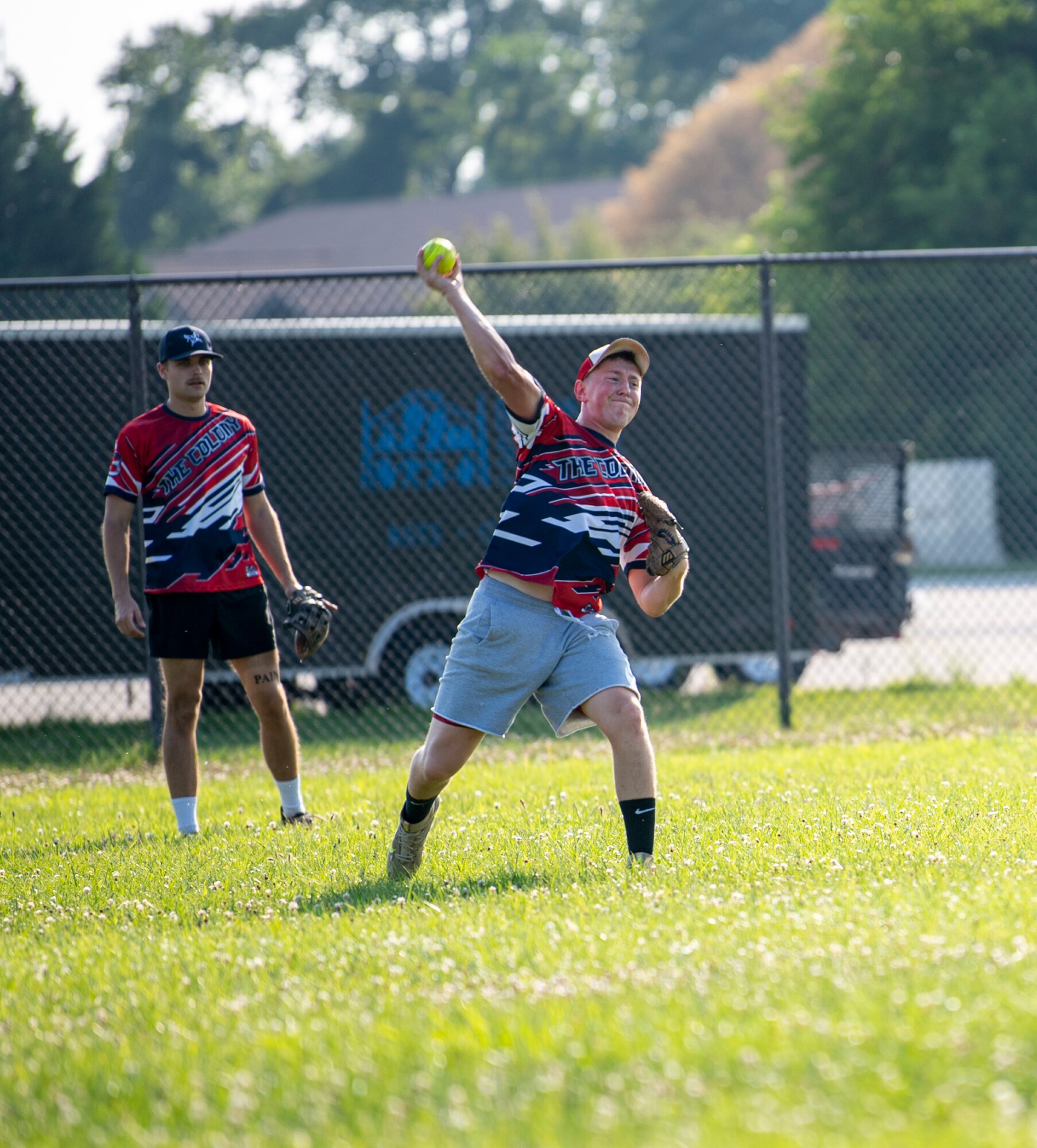 Staff Sgt. Jacob Dulcie, right, 436th Maintenance Squadron Isochronal Maintenance Dock aircraft inspection craftsman, throws a ball during an intramural softball game against the 436th Security Forces Squadron on Dover Air Force Base, Delaware, July 26, 2021. The 436th SFS won the game 13-4. (U.S. Air Force photo by Tech. Sgt. Nicole Leidholm)