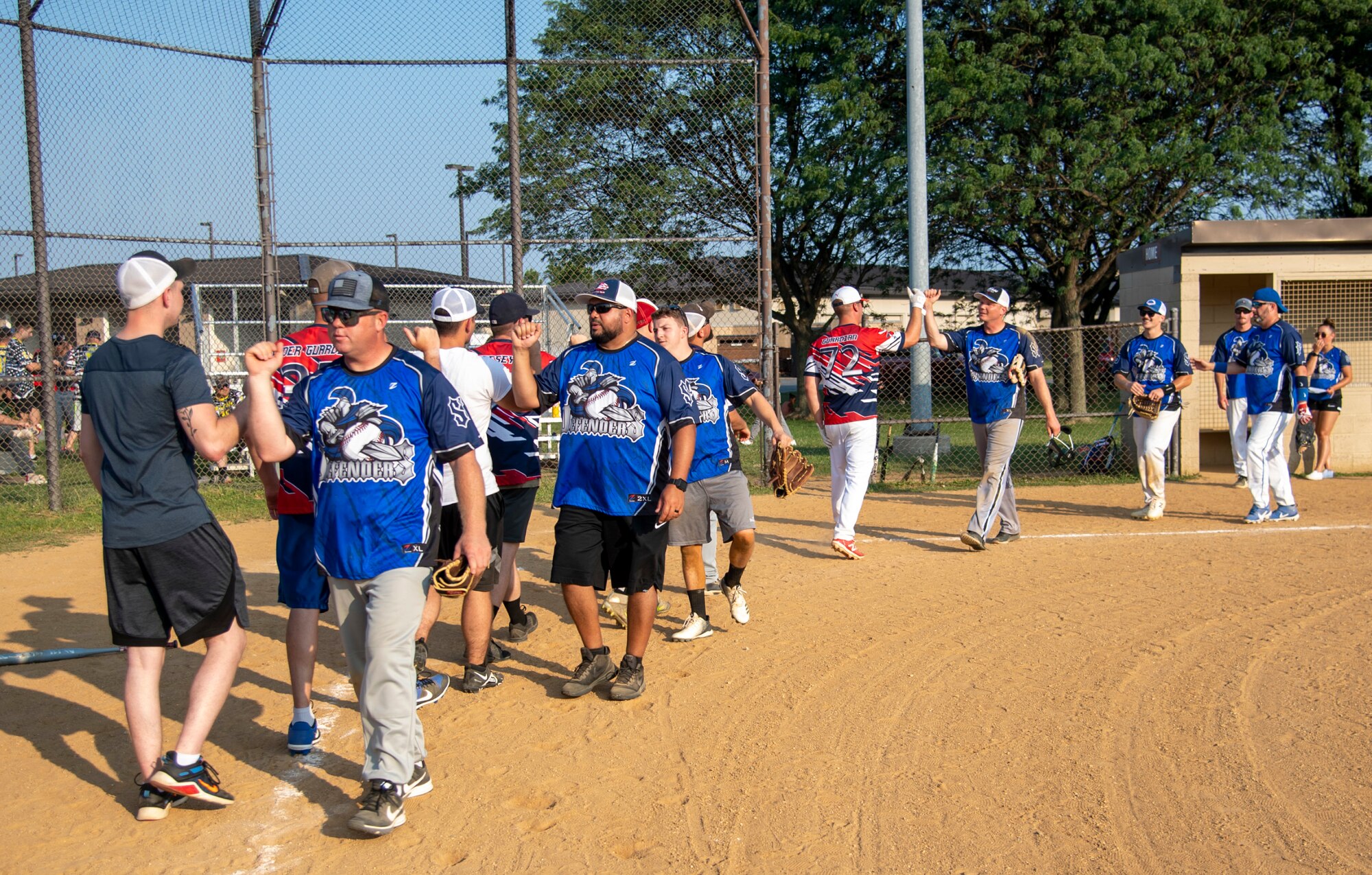 Airmen from the 436th Security Forces Squadron and 436th Maintenance Squadron Isochronal Maintenance Dock congratulate each other after an intramural softball game on Dover Air Force Base, Delaware, July 26, 2021. The 436th SFS won the game 13-4. (U.S. Air Force photo by Tech. Sgt. Nicole Leidholm)