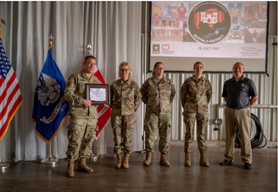 Photo By Senior Airman Kelsey Martinez | Lt. Col. Eli Adams, U.S. Army Corps of Engineers Buffalo District commander, presents a certificate of appreciation to the airmen of the 914th Aeromedical Staging Squadron, N.Y. in recognition of their efforts to vaccinate the USACE Buffalo District staff during the height of the COVID-19 pandemic. Lt. Col. Shelly Durante, Senior Master Sgt. Rebecca Platt and Capt. Tara Gensler recieved the award on behalf of the 914th ASTS team.