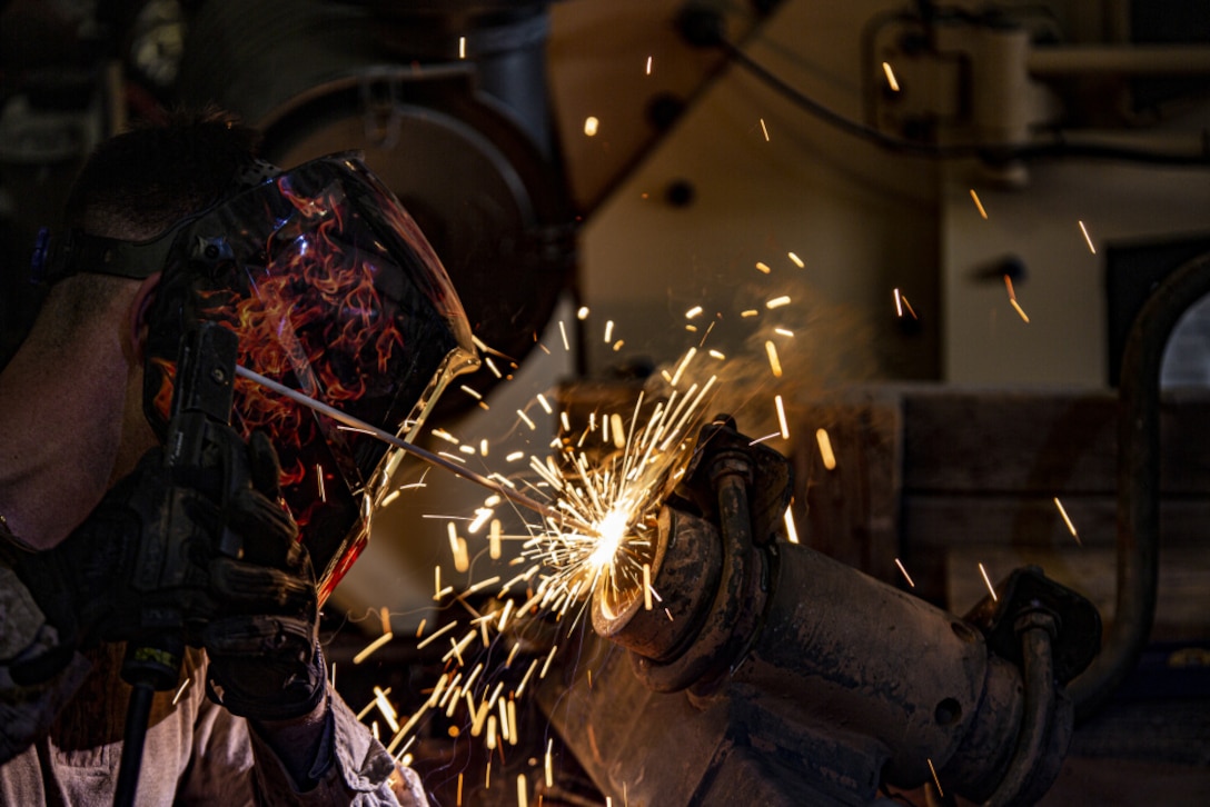 U.S. Marine Sgt. Anthoney Cook assigned to the 24th Marine Expeditionary Unit, welds a landing leg for a trailer at Ahamad al-Jaber Air Base, Kuwait, July 21,2021. 24th MEU is deployed to the U.S. 5th Fleet area of operations in support of naval operations to ensure maritime stability and security in the Central Region, connecting the Mediterranean and Pacific through the Western Indian Ocean and three strategic choke points.