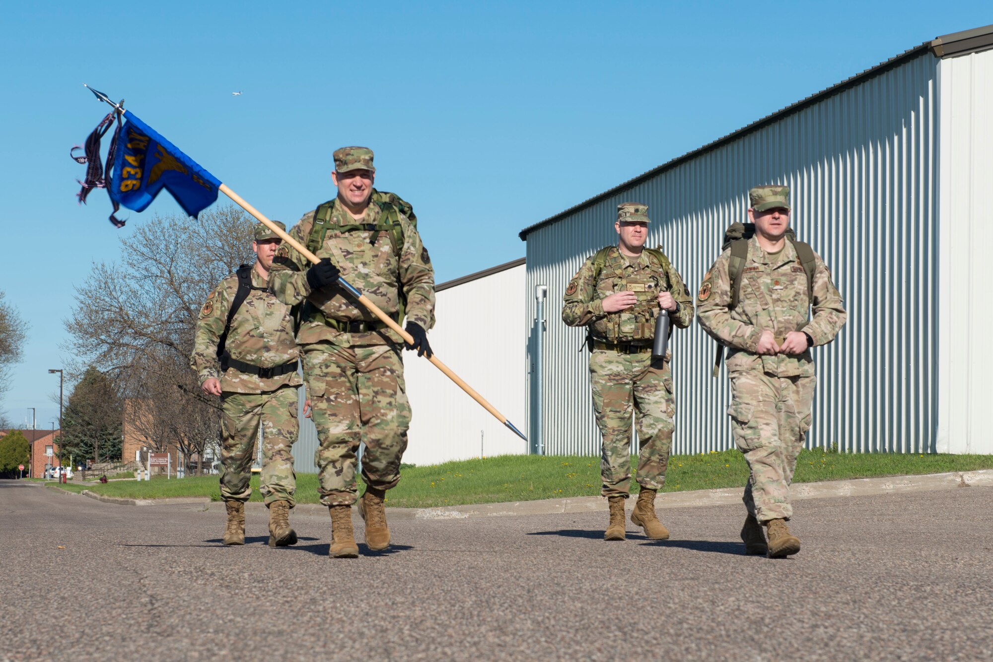 Master Sgt. Glen Kramlinger (front left), 934th Security Forces Squadron plans and programs manger, Maj. Ryan Buatala (front right), 934th Security Forces Squadron operations officer, Master Sgt. Kory Soderquist (back left), 934th Security Forces Squadron chief of training, and Lt. Col. Charles Trovarello (back right), 934th Security Forces Squadron commander, each carry 40-pound ruck sacks during a 4.5 mile ruck march in support of the Resolute Defender Ruck Challenge at Minneapolis-St. Paul Air Reserve Station, April 30, 2021. The intent for this 12 month challenge is to build and solidify resiliency, camaraderie, and communication. Currently, 40 Airmen and civilians, comprising 19 different teams, are taking part in the challenge. (Air Force photo by Chris Farley)