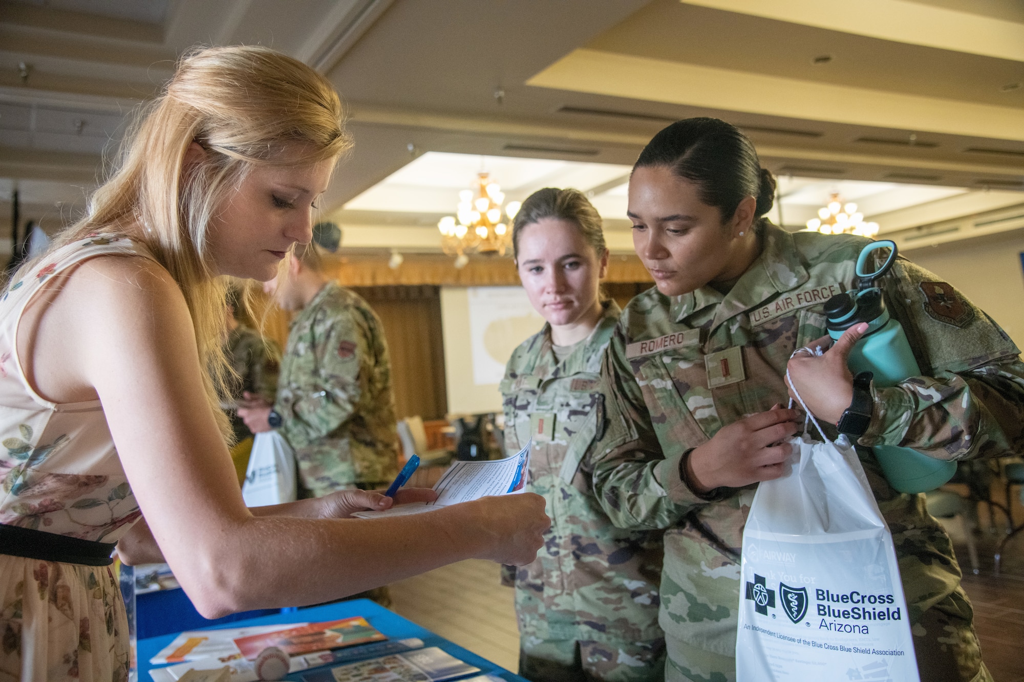 Sonya Struble, left, 56th Force Support Squadron Airman & Family Readiness Center Exceptional Family Member Program-Family Support coordinator, reads a pamphlet along with 2nd Lt. Baylor Burt, center, 56th FSS readiness officer, and 2nd Lt. Jaelyn Romero, 56th FSS community service deputy, during a wing newcomer’s orientation July 20, 2021, at Luke Air Force Base, Arizona. All Department of Defense cardholders and their families can utilize EFMP services such as local community services, education and outreach, early intervention services and individualized care plans. The EFMP helps support Airmen and their families by providing specialized services to aid in enhancing their quality of life and level of resiliency. (U.S. Air Force photo by Staff Sgt. Collette Brooks)