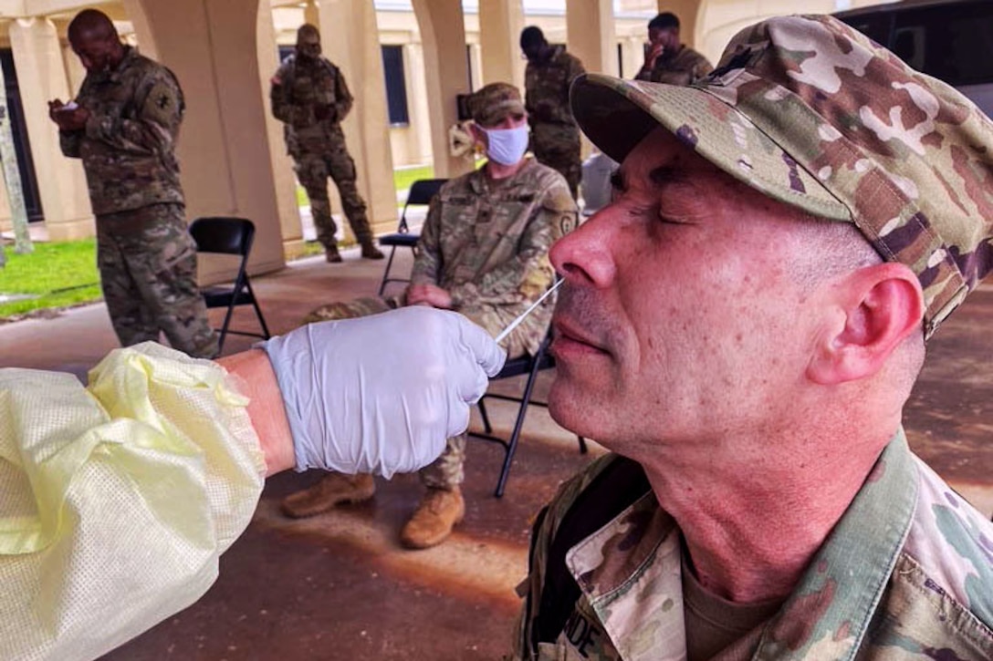 A soldier gets a nasal swab.­