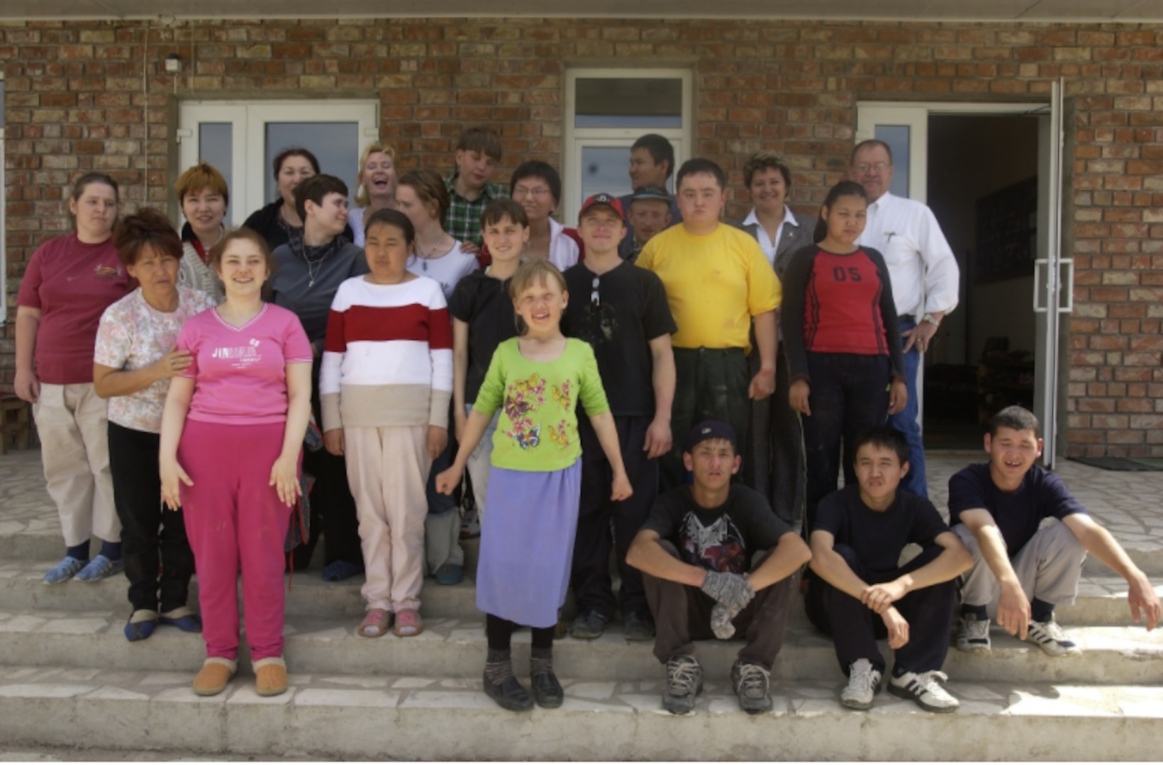 Students and staff line up for a picture in front of the Uventus Center outside of Bishkek, Kyrgyzstan. The school teaches work skills to special needs children.