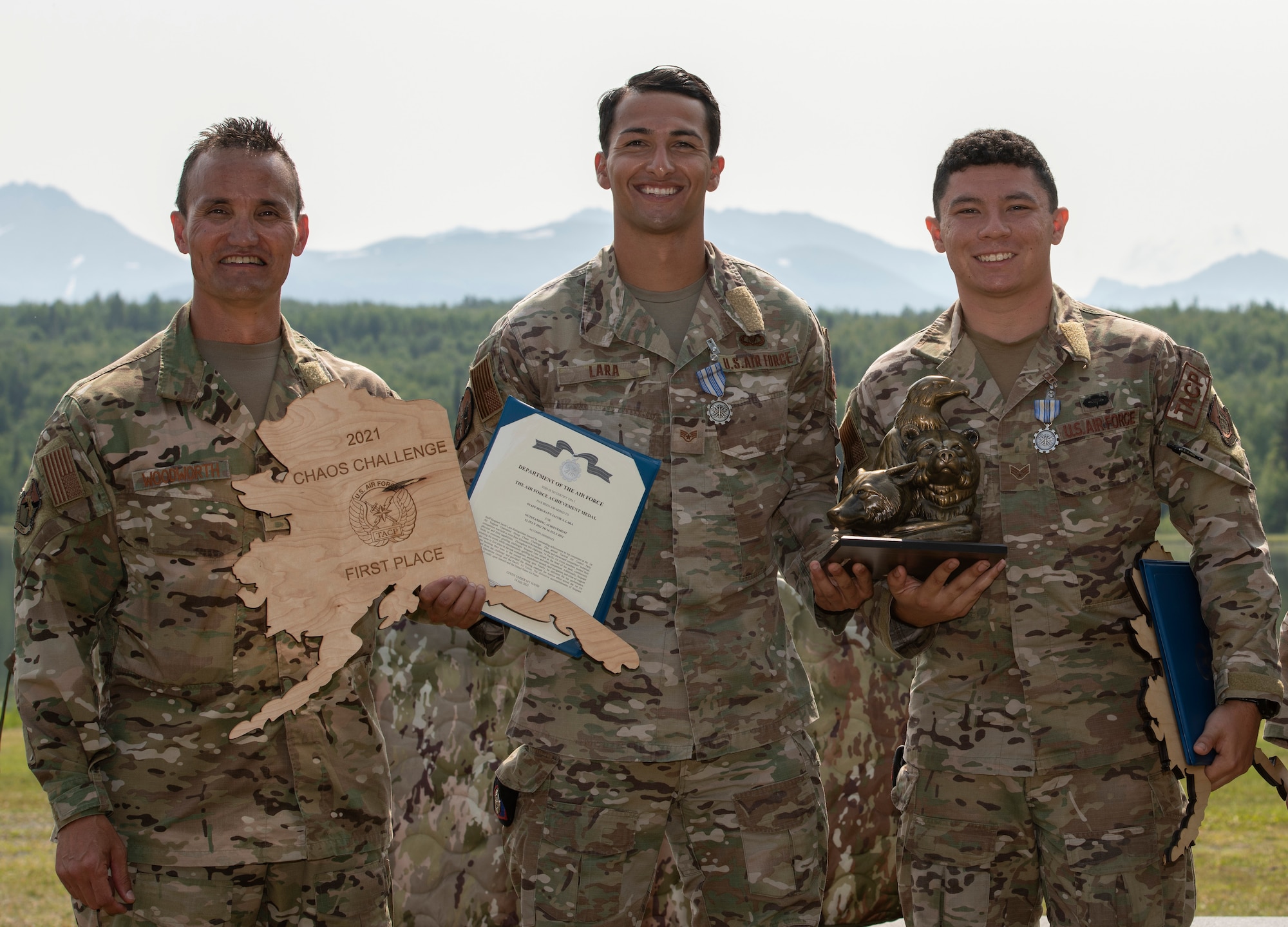 U.S. Air Force Col. Travis Woodworth, left, Commander, 1st Air Support Operations Group pauses for photo with the winners of the Chaos Challenge 2021, Staff Sgt. Jacob Lara, center, and Senior Airman Matthew Arellano, 25th Air Support Operations Squadron at Joint Base Elmendorf-Richardson, Alaska, July 16, 2021. The Chaos Challenge 2021 was a multi-day series of mental and physical contests sponsored by the 1st Air Support Operations Group with participants from the 3rd, 5th, 25th, and 604th Air Support Operations Squadrons and a guest team from the 673d Security Forces Squadron. The winner of the competition will go on to compete in Lightning Challenge 2021 to determine the best two-man TACP team in the Air Force.