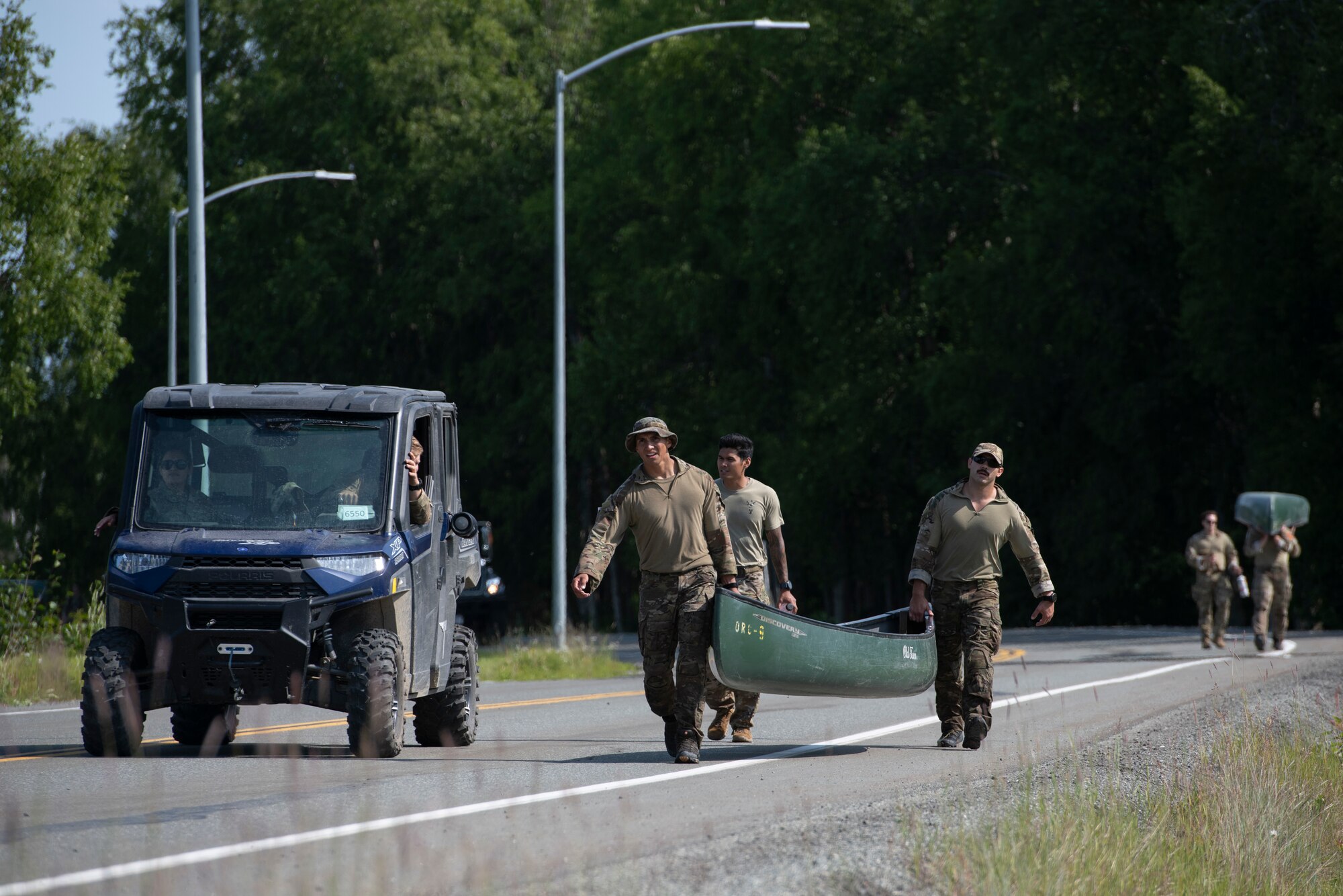 U.S. Air Force tactical air control party (TACP) specialists from the 1st Air Support Operations Group, carry their canoes while competing in the Chaos Challenge 2021 at Joint Base Elmendorf-Richardson, Alaska, July 15, 2021. The Chaos Challenge 2021 was a multi-day series of mental and physical contests sponsored by the 1st Air Support Operations Group with participants from the 3rd, 5th, 25th, and 604th Air Support Operations Squadrons and a guest team from the 673d Security Forces Squadron. The winner of the competition will go on to compete in Lightning Challenge 2021 to determine the best two-man TACP team in the Air Force.