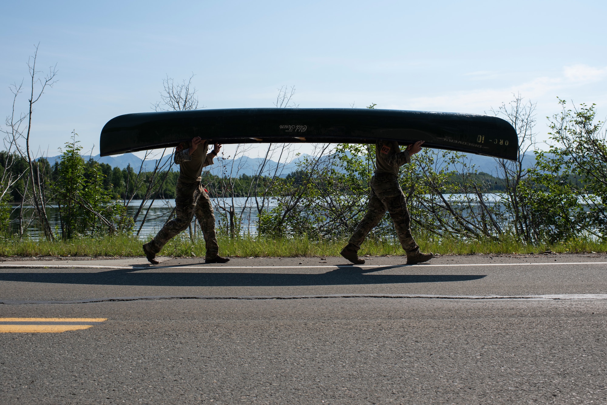 U.S. Air Force Staff Sgt. Jacob Lara, left, and Senior Airman Matthew Arellano, tactical air control party (TACP) specialists, 25th Air Support Operations Squadron, carry their canoe while competing in the Chaos Challenge 2021 at Joint Base Elmendorf-Richardson, Alaska, July 15, 2021. The Chaos Challenge 2021 was a multi-day series of mental and physical contests sponsored by the 1st Air Support Operations Group with participants from the 3rd, 5th, 25th, and 604th Air Support Operations Squadrons and a guest team from the 673d Security Forces Squadron. The winner of the competition will go on to compete in Lightning Challenge 2021 to determine the best two-man TACP team in the Air Force.
