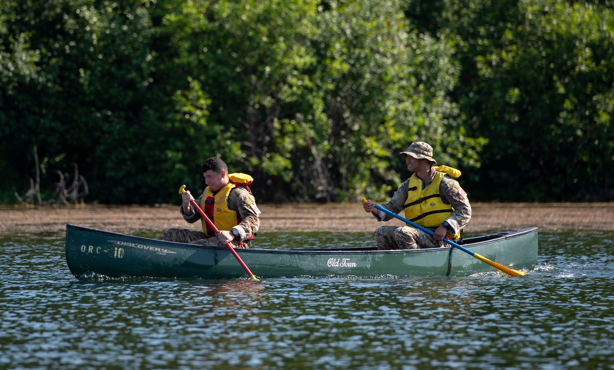 U.S. Air Force Senior Airman Matthew Arellano, left, and Staff Sgt. Jacob Lara, tactical air control party (TACP) specialists, 25th Air Support Operations Squadron, canoe across 6-mile Lake while competing in the Chaos Challenge 2021 at Joint Base Elmendorf-Richardson, Alaska, July 15, 2021. The Chaos Challenge 2021 was a multi-day series of mental and physical contests sponsored by the 1st Air Support Operations Group with participants from the 3rd, 5th, 25th, and 604th Air Support Operations Squadrons and a guest team from the 673d Security Forces Squadron. The winner of the competition will go on to compete in Lightning Challenge 2021 to determine the best two-man TACP team in the Air Force.