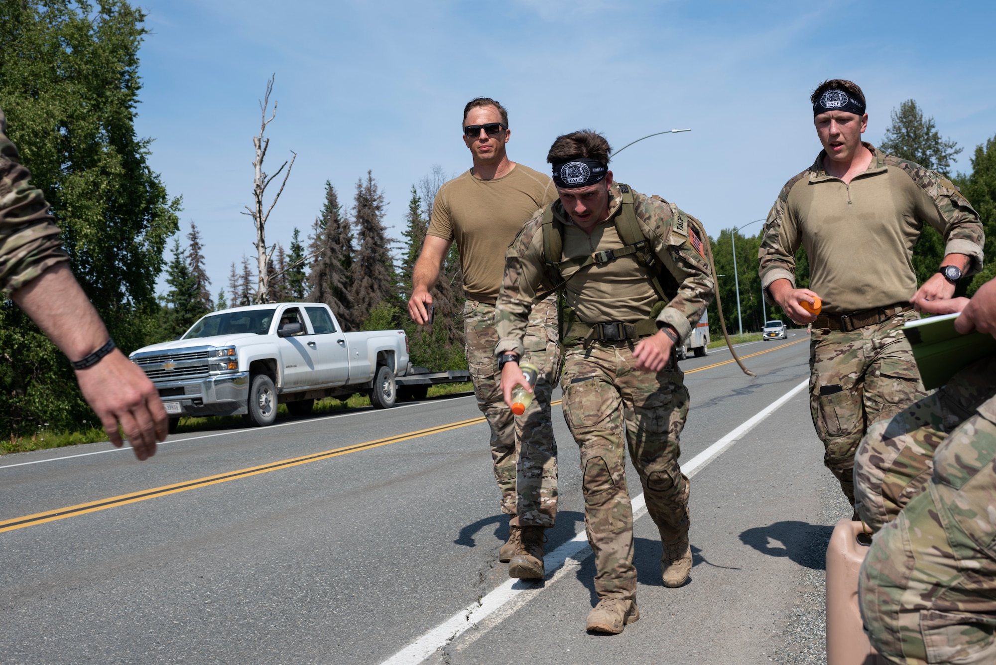 U.S. Air Force Airman 1st Class Maverick Duffy, center, tactical air control party (TACP) specialist, 5th Air Support Operations Squadron, approaches the finish during a ruck run for the Chaos Challenge 2021 at Joint Base Elmendorf-Richardson, Alaska, July 14, 2021. The Chaos Challenge 2021 was a multi-day series of mental and physical contests sponsored by the 1st Air Support Operations Group with participants from the 3rd, 5th, 25th, and 604th Air Support Operations Squadrons and a guest team from the 673d Security Forces Squadron. The winner of the competition will go on to compete in Lightning Challenge 2021 to determine the best two-man TACP team in the Air Force.