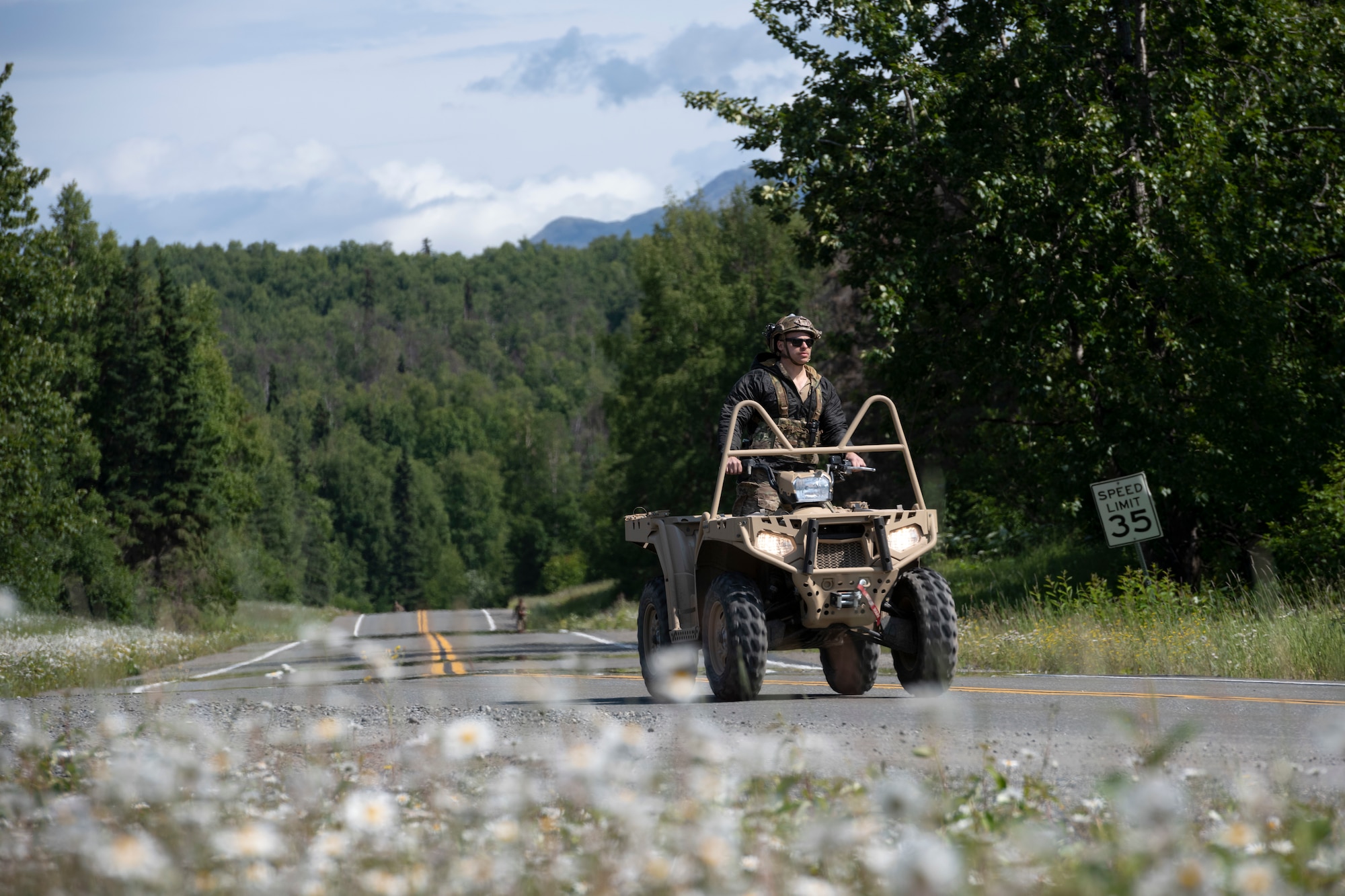 U.S. Air Force Staff Sgt. Austin George, tactical air control party (TACP) specialist, 3rd Air Support Operations Squadron, rides an all-terrain vehicle while monitoring a ruck run during the Chaos Challenge 2021 at Joint Base Elmendorf-Richardson, Alaska, July 14, 2021. The Chaos Challenge 2021 was a multi-day series of mental and physical contests sponsored by the 1st Air Support Operations Group with participants from the 3rd, 5th, 25th, and 604th Air Support Operations Squadrons and a guest team from the 673d Security Forces Squadron. The winner of the competition will go on to compete in Lightning Challenge 2021 to determine the best two-man TACP team in the Air Force.