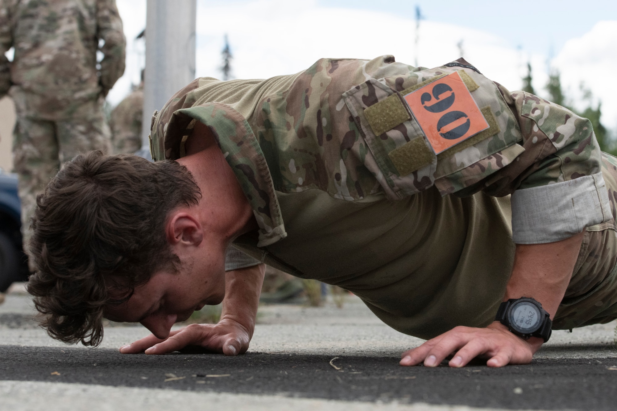 U.S. Air Force Senior Staff Sgt. Garrett Geske, tactical air control party (TACP) specialist, 3rd Air Support Operations Squadron, performs push-ups during the Chaos Challenge 2021 at Joint Base Elmendorf-Richardson, Alaska, July 13, 2021. The Chaos Challenge 2021 was a multi-day series of mental and physical contests sponsored by the 1st Air Support Operations Group with participants from the 3rd, 5th, 25th, and 604th Air Support Operations Squadrons and a guest team from the 673d Security Forces Squadron. The winner of the competition will go on to compete in Lightning Challenge 2021 to determine the best two-man TACP team in the Air Force.