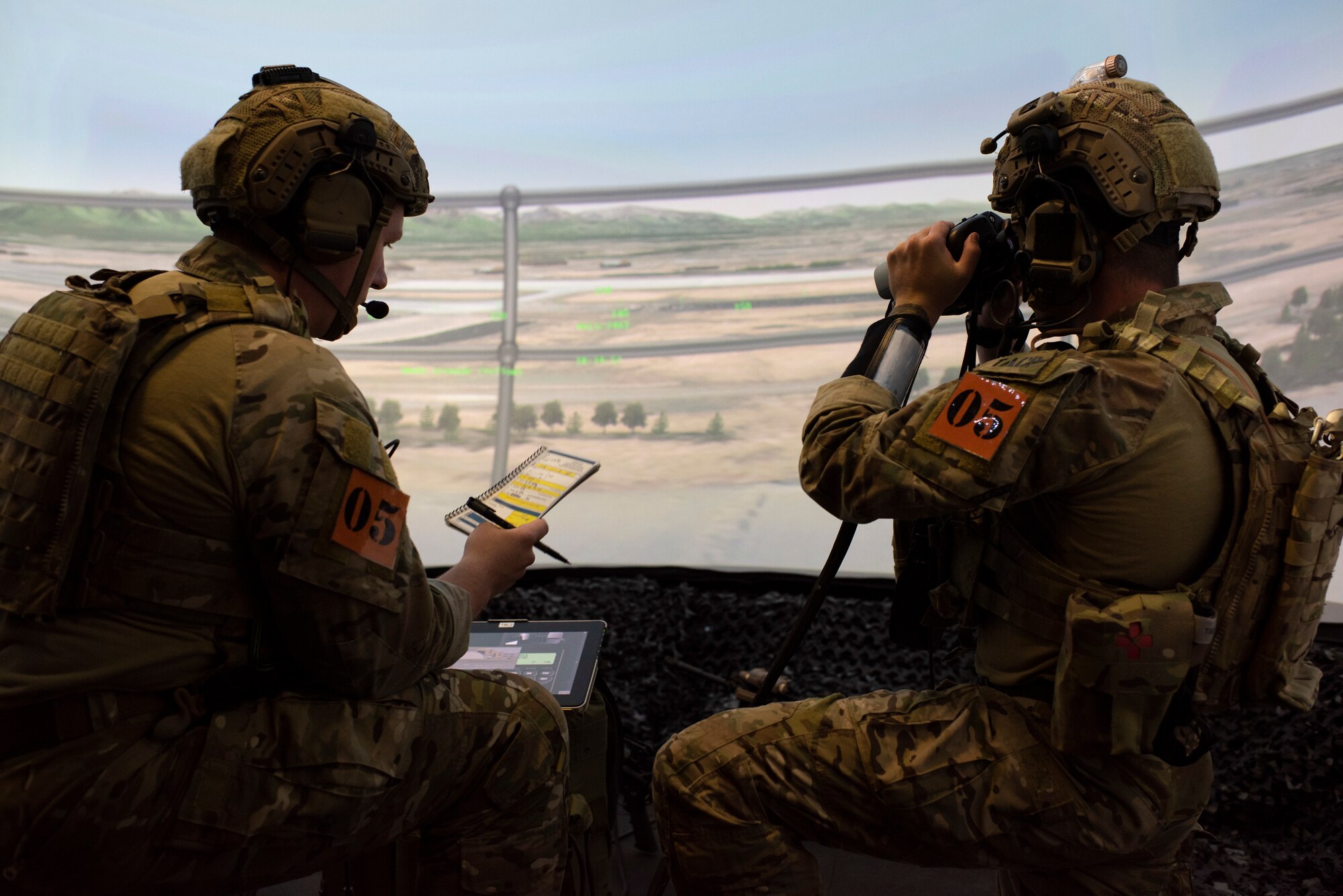 U.S. Air Force Senior Airman Brandon Mason, left, and Airman 1st Class Maverick Duffy, tactical air control party (TACP) specialists, 5th Air Support Operations Squadron, utilize the Advanced Joint Terminal Attack Controller Training System to conducted a simulated air support mission during the Chaos Challenge 2021 at Joint Base Elmendorf-Richardson, Alaska, July 13, 2021. The Chaos Challenge 2021 was a multi-day series of mental and physical contests sponsored by the 1st Air Support Operations Group with participants from the 3rd, 5th, 25th, and 604th Air Support Operations Squadrons and a guest team from the 673d Security Forces Squadron. The winner of the competition will go on to compete in Lightning Challenge 2021 to determine the best two-man TACP team in the Air Force.