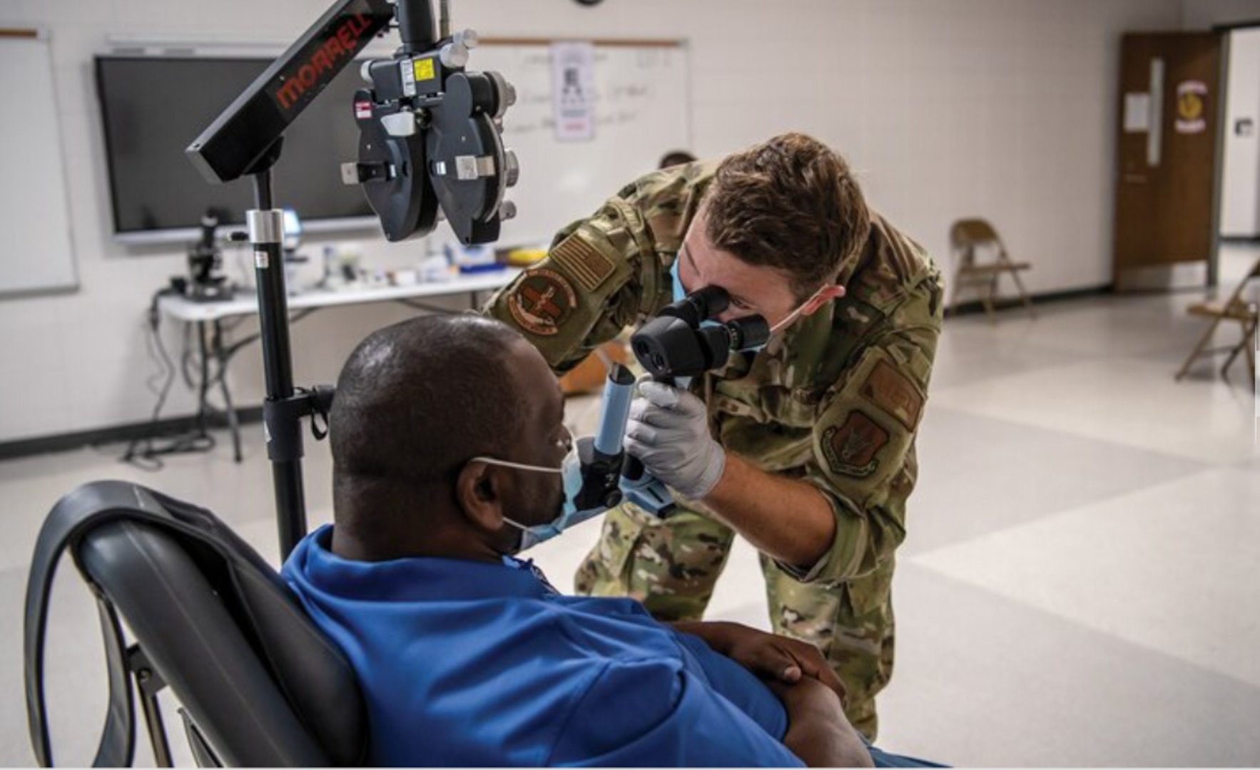 Capt. Adam Fannin, 445th Aerospace Medicine Squadron optometrist, assesses a patient at Jenkins County High School, Waynesboro, Georgia, as part of East Central Georgia Medical Innovative Readiness Training, June 9, 2021. (U.S. Air Force photo by Master Sgt. Patrick O'Reilly)