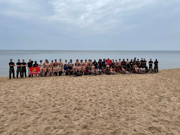 United States Marine Corps recruiters with Recruiting Station Lansing, lead a high-intensity, beach workout with local high school athletes at Pere Marquette Park, Muskegon, Michigan, July 16, 2021. The recruiters created this workout to challenge the personal preconceived limitations of the participants. (U.S. Marine Corps photo by Cpl. Jesse Carter-Powell)