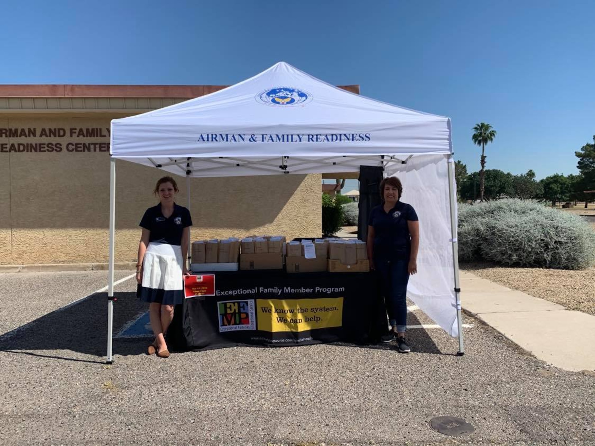 Sonya Struble, left, and Senaida Larson, right, both 56th Force Support Squadron Airman & Family Readiness Center Exceptional Family Member Program-Family Support coordinators, host a “Grab and Go” event May 5, 2020, at Luke Air Force Base, Arizona. In order to stay connected with families, yet socially distanced due to the COVID-19 pandemic, Struble and Larson hosted a drive-thru event that provided families an at-home pottery kit to enhance their morale and time together. The EFMP helps support Airmen and their families by providing specialized services to aid in enhancing their quality of life and level of resiliency. (Courtesy photo)