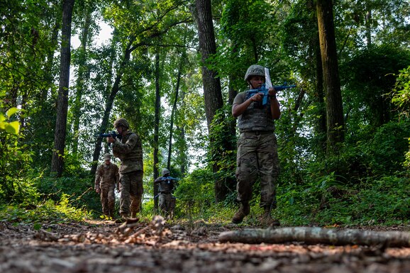 Airmen from the 4th Civil Engineer Squadron patrol the woods as part of the Prime Base Engineer Emergency Force, or Prime BEEF, program at Seymour Johnson Air Force Base, North Carolina, July 22, 2021. The Prime BEEF program gives Airmen a chance to complete all their required training in a three-day period. (U.S. Air Force photo by Airman 1st Class David Lynn)