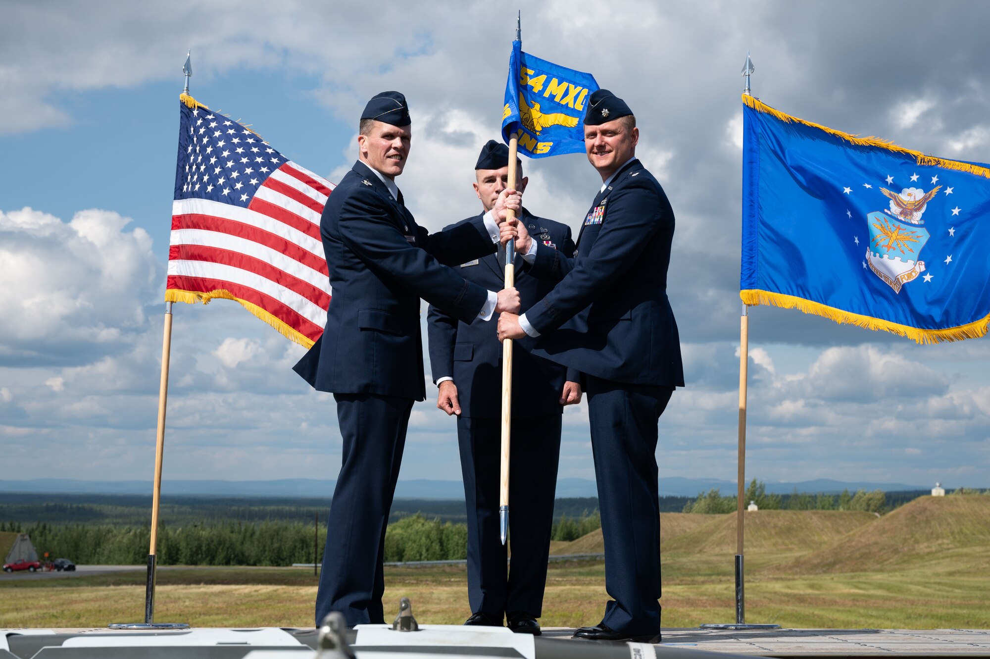 U.S. Air Force Col. Matthew Powell, (left), the 354th Maintenance Group commander, and Lt. Col. Cory Helms, the 354th Munitions Squadron commander, pose for a photo during an assumption of command ceremony on Eielson Air Force Base, Alaska, July 26, 2021.