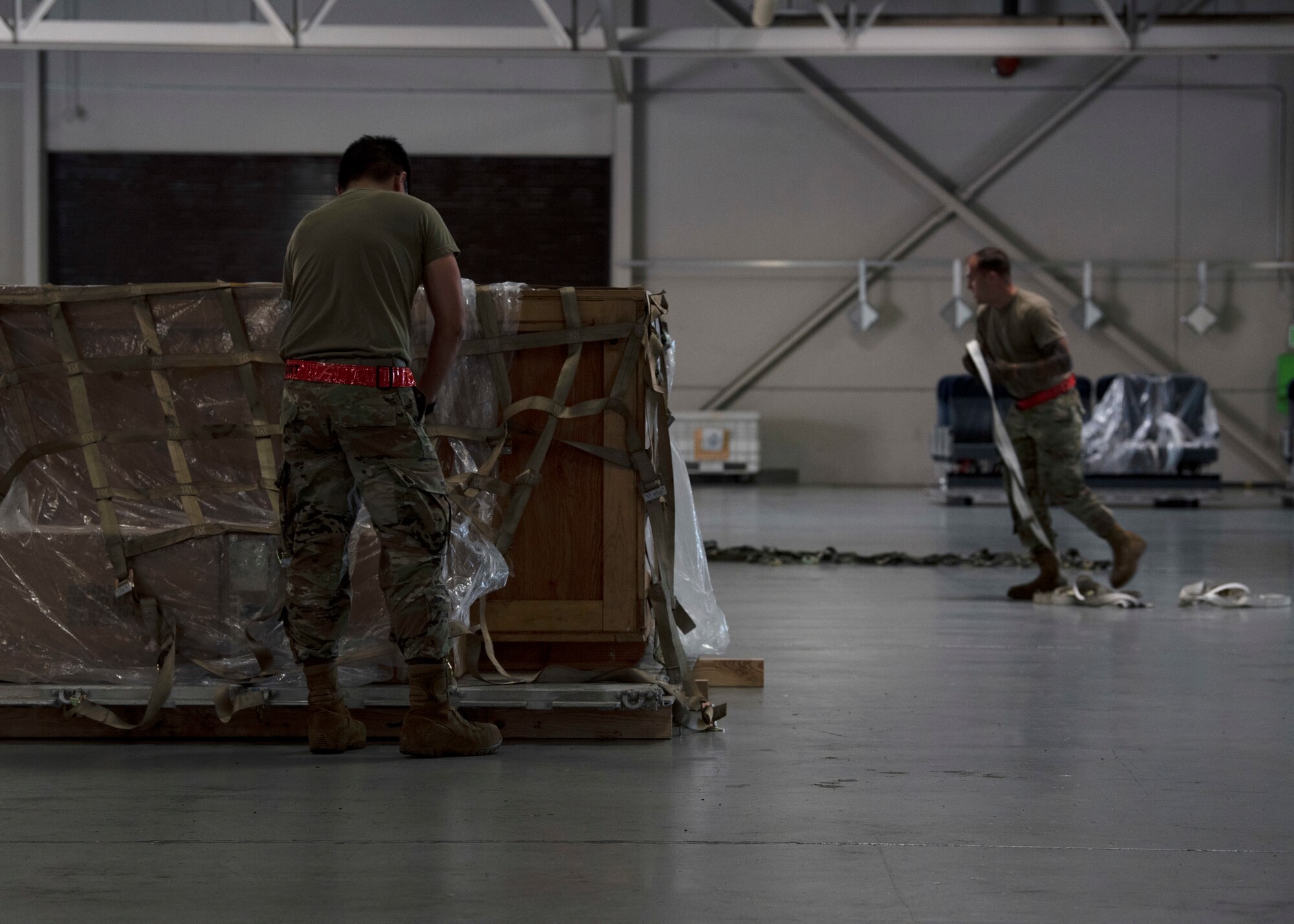 (From left) U.S. Air Force Airman 1st Class Gian Barranco and Airman 1st Class Clay Huddleston, both ramp operations representatives with the 62nd Aerial Port Squadron, participate in a pallet building challenge as part of the Eagle Port Rodeo Team tryouts at Joint Base Lewis-McChord, Washington, June 24, 2021. The chosen team will receive an opportunity to represent the 62nd APS at a Port Dawgs competition at Joint Base Pearl Harbor-Hickam, Hawaii. (U.S. Air Force photo by Senior Airman Zoe Thacker)