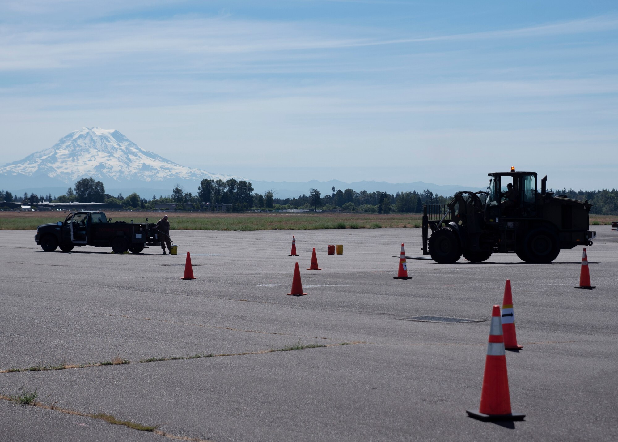 An Airman with the 62nd Aerial Port Squadron operates a forklift during a skills course for the Eagle Port Rodeo Team tryouts at Joint Base Lewis-McChord, Washington, June 24, 2021. The participants took part in five events: a pallet build-up competition, a 10K forklift skills course, a simulated aircraft upload, a combat fitness challenge and a knowledge test based on their Air Force specialty codes. (U.S. Air Force photo by Senior Airman Zoe Thacker)