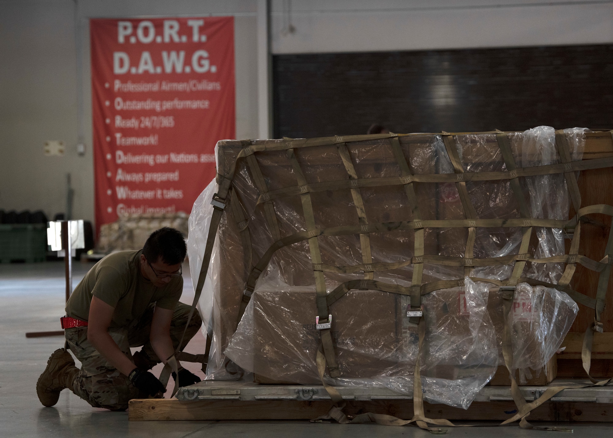 U.S. Air Force Airman 1st Class Gian Barranco, 62nd Aerial Port Squadron ramp operations representative, participates in a pallet building challenge as part of the Eagle Port Rodeo Team tryouts at Joint Base Lewis-McChord, Washington, June 24, 2021. The participants took part in five events: a pallet build-up competition, a 10K forklift skills course, a simulated aircraft upload, a combat fitness challenge and a knowledge test based on their Air Force specialty codes. (U.S. Air Force photo by Senior Airman Zoe Thacker)