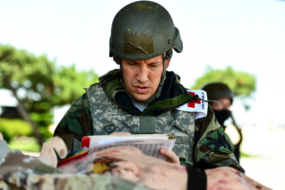 An Airman treats a simulated patient.