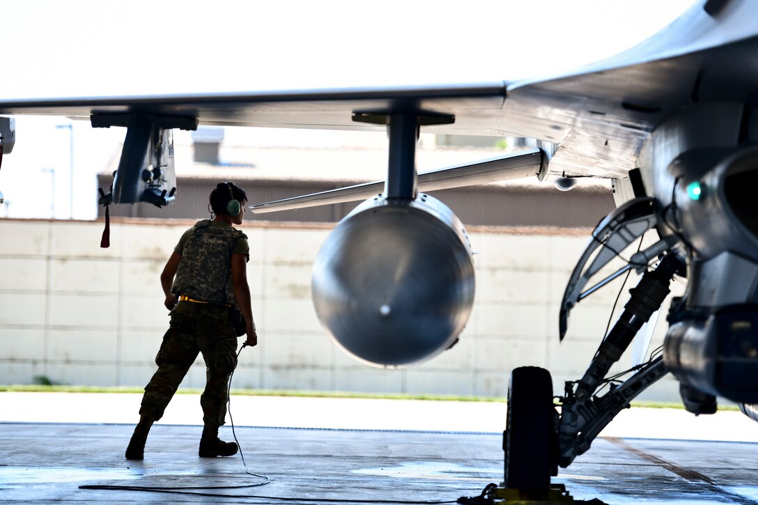A maintainer inspects a jet.