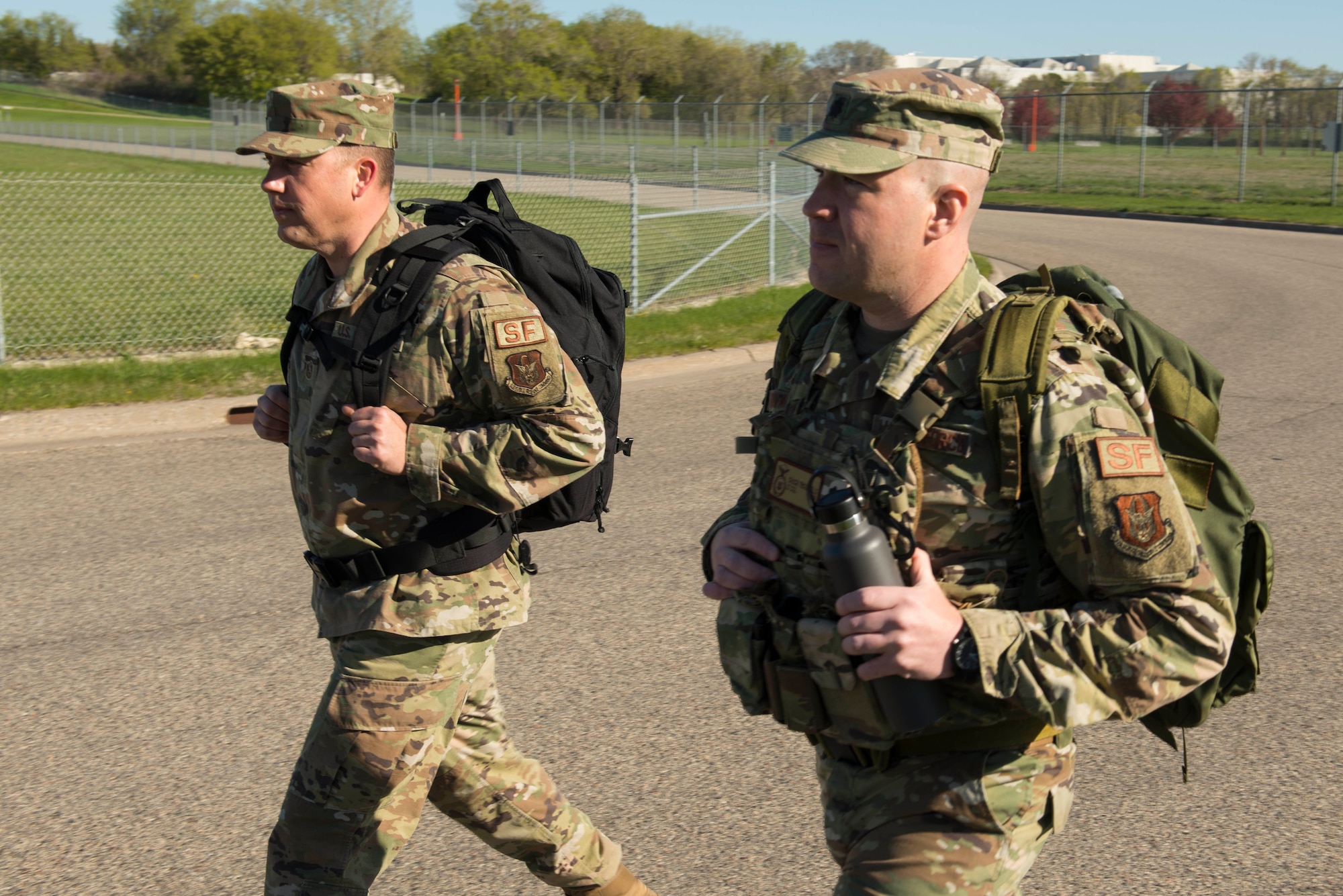 Master Sgt. Kory Soderquist (back left), 934th Security Forces Squadron chief of training, and Lt. Col. Charles Trovarello (back right), 934th Security Forces Squadron commander, each carry 40-pound ruck sacks during a 4.5 mile ruck march in support of the Resolute Defender Ruck Challenge at Minneapolis-St. Paul Air Reserve Station, April 30, 2021. The intent for this 12 month challenge is to build and solidify resiliency, camaraderie, and communication. Currently, 40 Airmen and civilians, comprising 19 different teams, are taking part in the challenge. (Air Force photo by Chris Farley)