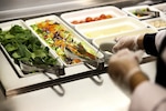 A photo shows food on a salad bar.